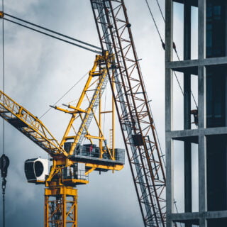 Construction tower cranes on a building site
