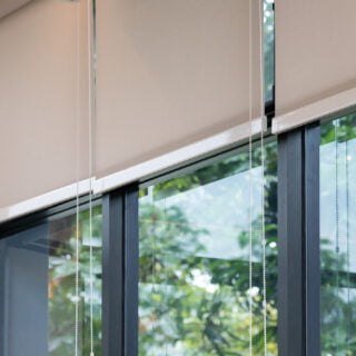 white curtain or white blinds Roller sun protection in the office with garden view background.